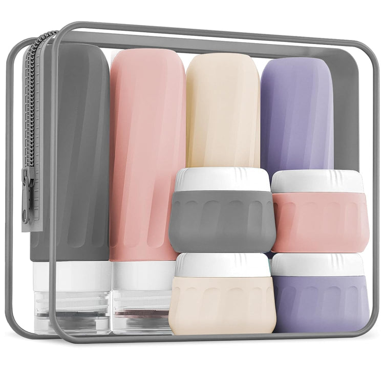 Assorted refillable beauty containers including empty bottles, jars, droppers, pumps, and roller bottles arranged neatly